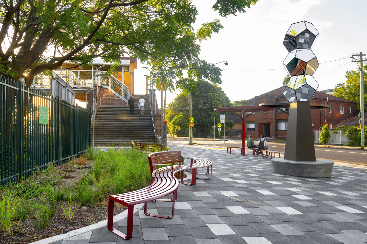 Linea Curved Seats and Benches with aluminium Spotted Gum battens and Pioneer Red battens, Pioneer Red frames.