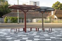ChillOUT Tree in Pioneer Red with Champagne perforated roof, and Textura Jasper with solid Shale Grey roof. Linea Curved Benches with aluminium Spotted Gum battens, Pioneer Red frames.
